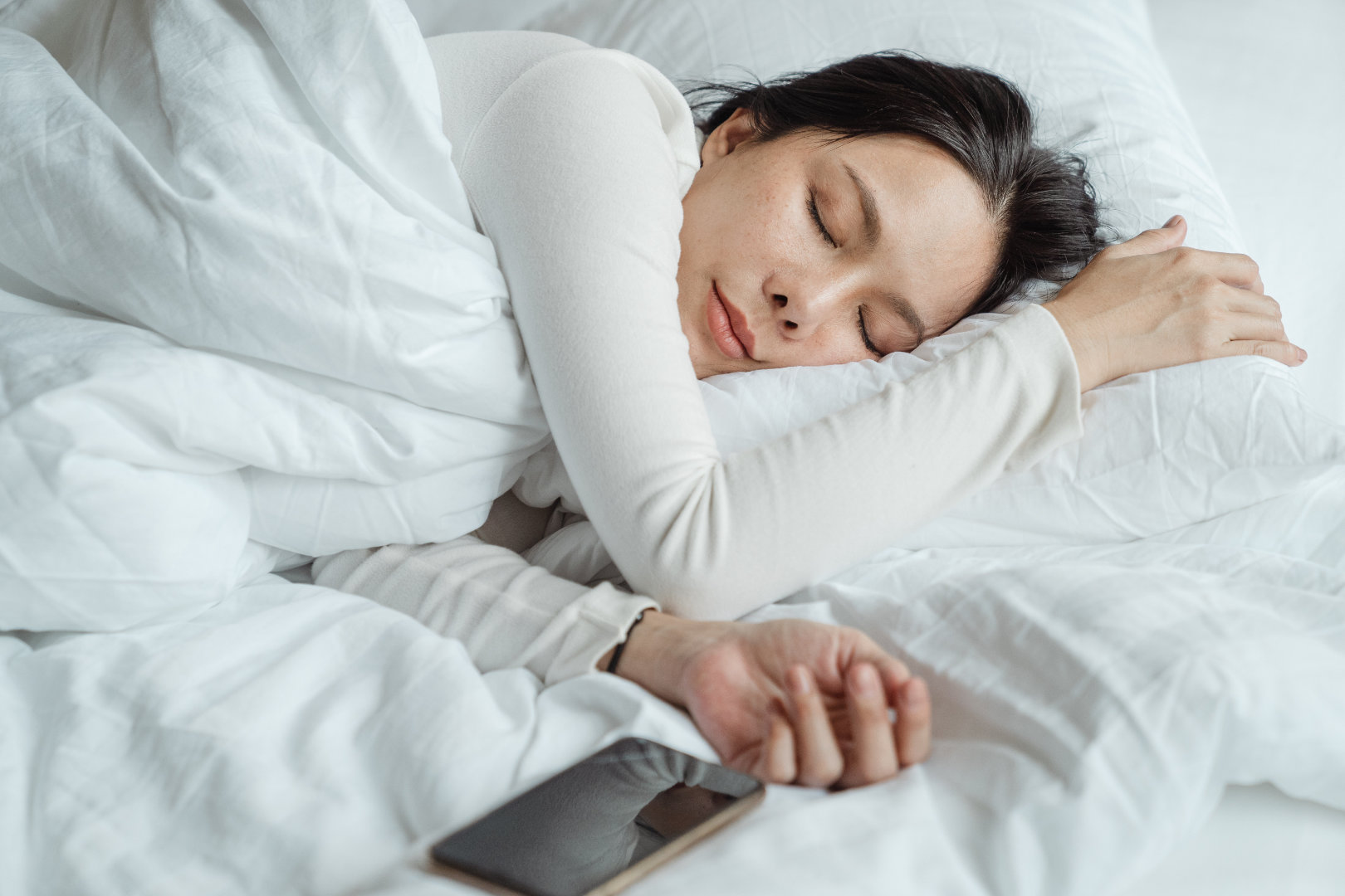 Woman peacefully sleeping in bed